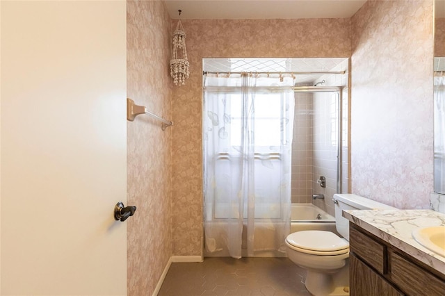 full bathroom with toilet, tile patterned floors, vanity, and bath / shower combo with glass door