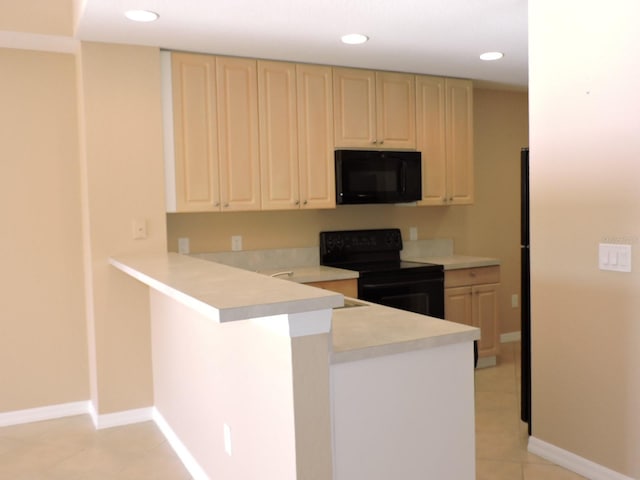 kitchen with sink, kitchen peninsula, light tile patterned floors, and black appliances