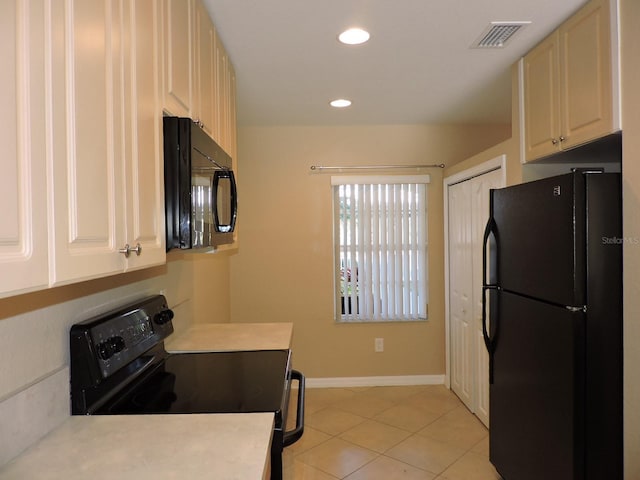 kitchen featuring light tile patterned flooring and black appliances