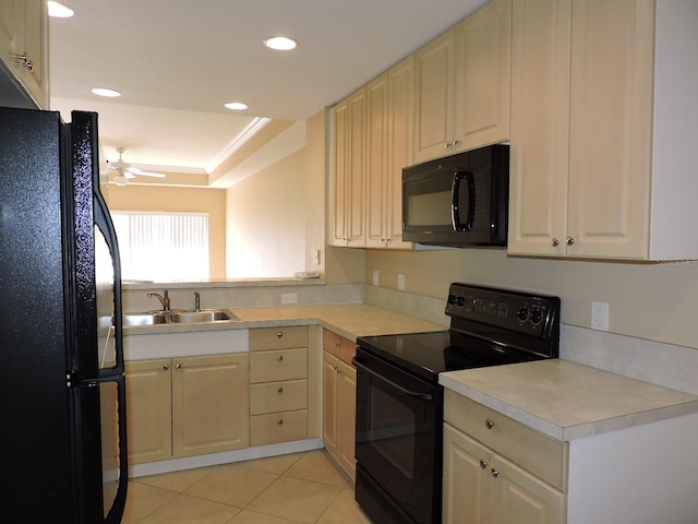 kitchen with sink, light tile patterned floors, a raised ceiling, ceiling fan, and black appliances