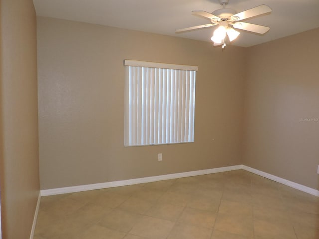 tiled spare room with ceiling fan