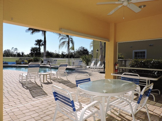 view of patio / terrace featuring a community pool and ceiling fan