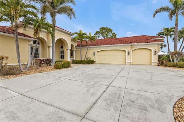 mediterranean / spanish-style house with a garage