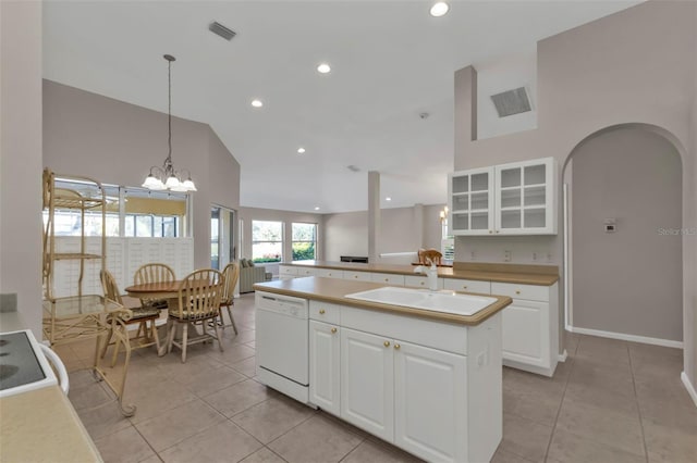 kitchen featuring white cabinetry, sink, an island with sink, and dishwasher