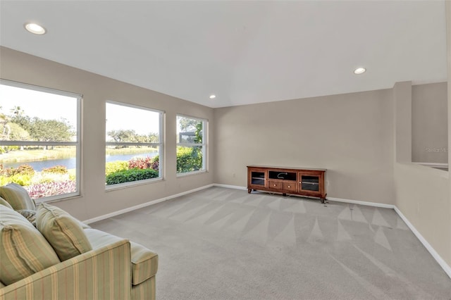 sitting room with a water view and light carpet