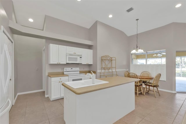 kitchen with white cabinetry, decorative light fixtures, a center island with sink, light tile patterned floors, and white appliances