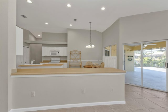 kitchen featuring ceiling fan with notable chandelier, white cabinets, hanging light fixtures, kitchen peninsula, and white appliances