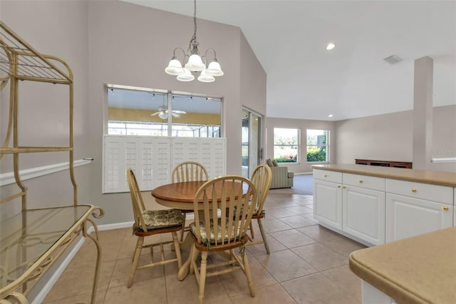 dining space featuring vaulted ceiling and light tile patterned floors