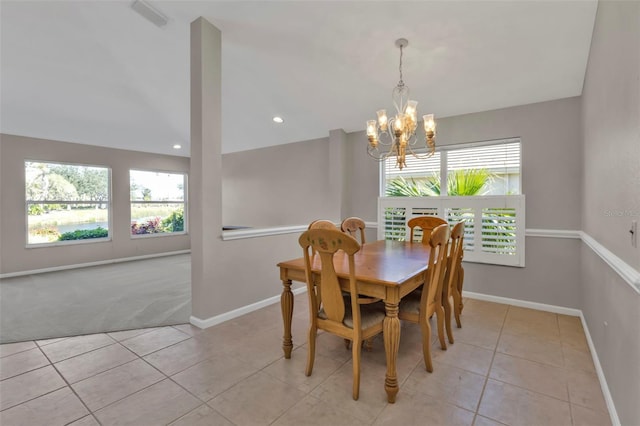 tiled dining room with an inviting chandelier, lofted ceiling, and a healthy amount of sunlight