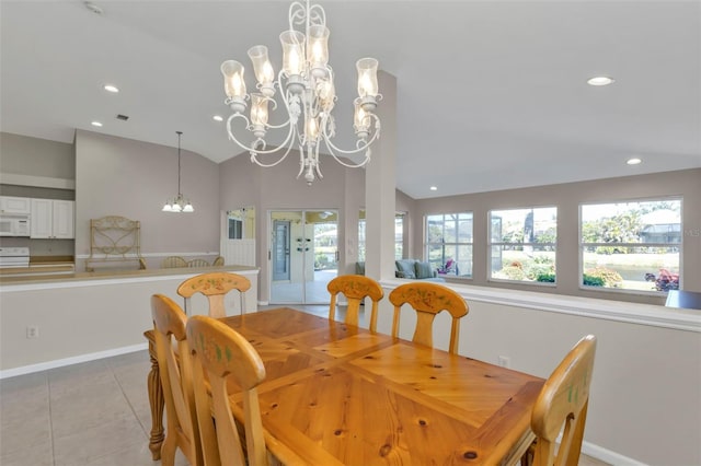 tiled dining room with lofted ceiling, an inviting chandelier, and french doors