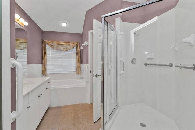 bathroom featuring vanity, tile patterned floors, and plus walk in shower