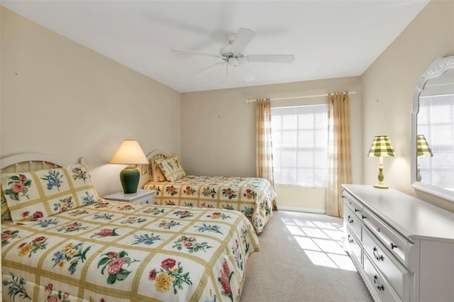 bedroom featuring light colored carpet and ceiling fan