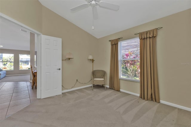 unfurnished room with ceiling fan, vaulted ceiling, light colored carpet, and a healthy amount of sunlight