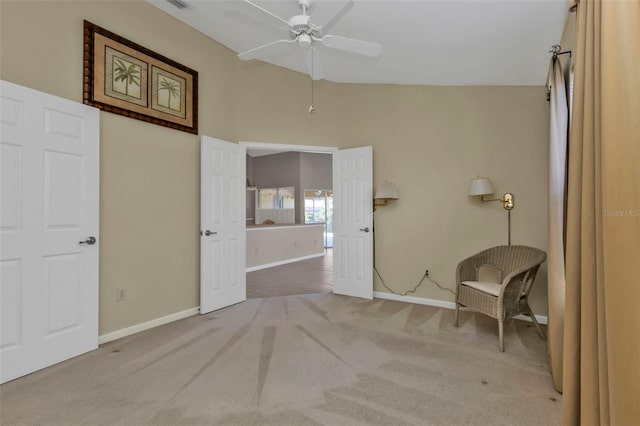 interior space with carpet, lofted ceiling, and ceiling fan