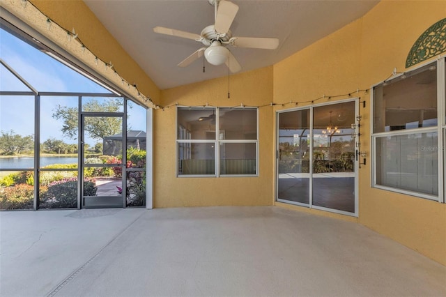 view of patio / terrace with a water view, ceiling fan, and a lanai