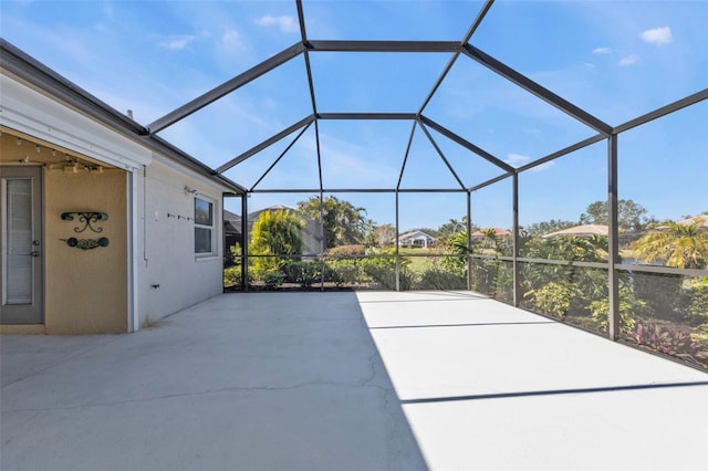 view of patio with glass enclosure