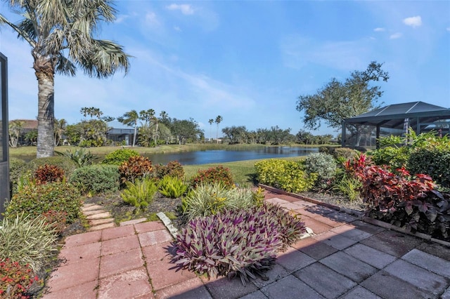 view of yard featuring a water view and glass enclosure