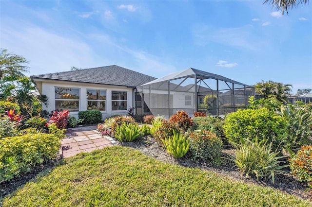 view of yard with glass enclosure