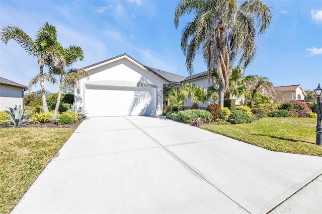 view of front of property with a garage and a front lawn