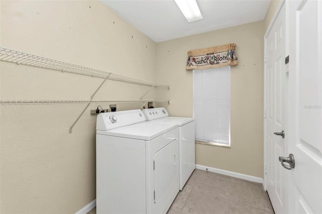 washroom featuring light tile patterned floors and washing machine and clothes dryer