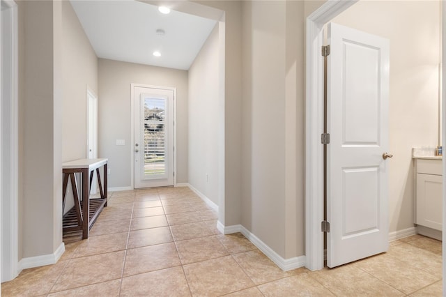 hall featuring light tile patterned floors