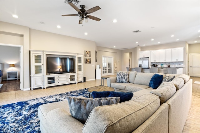 living room with light tile patterned floors and ceiling fan