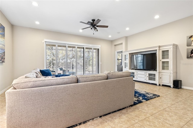 living room featuring light tile patterned floors and ceiling fan