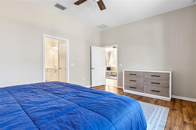 bedroom featuring ceiling fan, connected bathroom, and dark hardwood / wood-style flooring