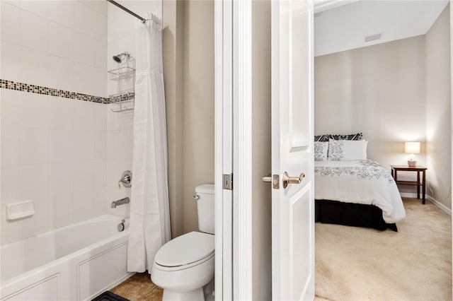 bathroom with toilet and shower / bath combo with shower curtain