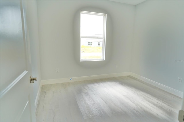 unfurnished room with light hardwood / wood-style flooring