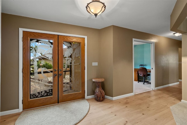 entrance foyer featuring light hardwood / wood-style floors and french doors