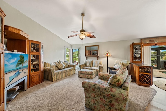 living room with vaulted ceiling, light colored carpet, and ceiling fan