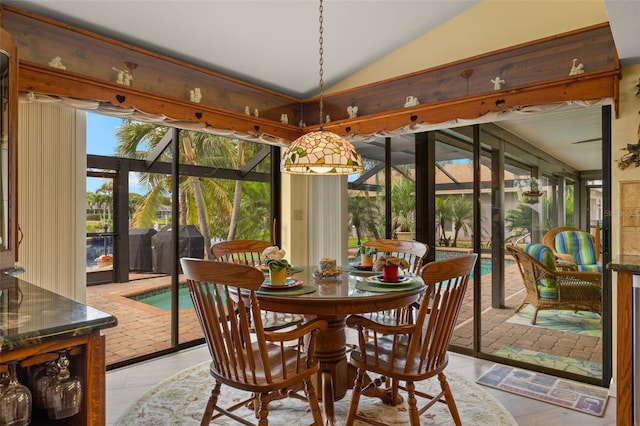 sunroom / solarium featuring vaulted ceiling