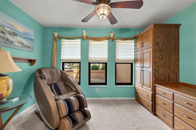 living area featuring ceiling fan and carpet flooring