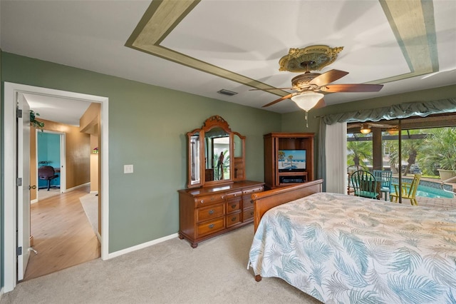 bedroom featuring access to outside, light colored carpet, and ceiling fan