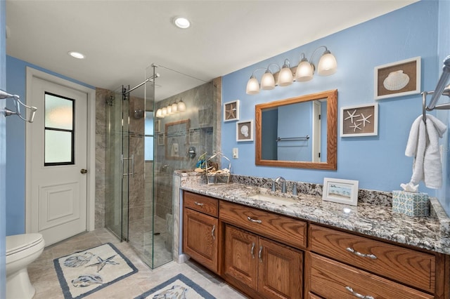 bathroom featuring vanity, toilet, and walk in shower