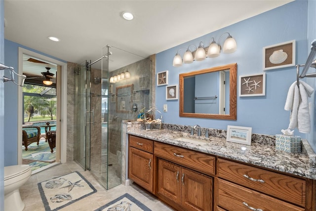 bathroom with tile patterned floors, vanity, toilet, and a shower with shower door