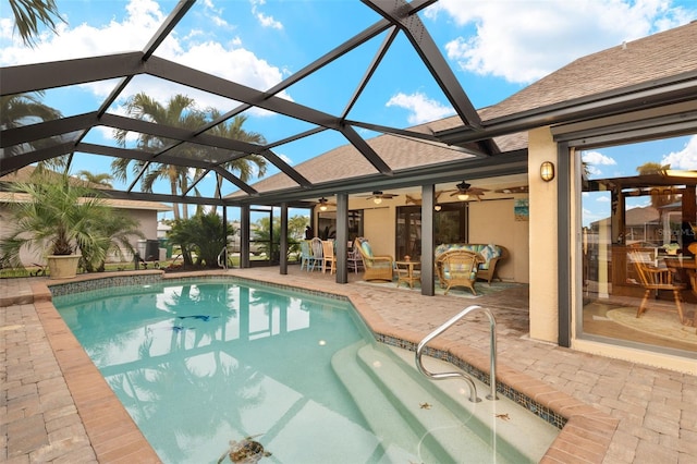 view of pool with a patio, an outdoor hangout area, ceiling fan, and glass enclosure