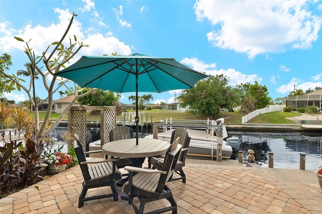 view of patio / terrace with a dock and a water view