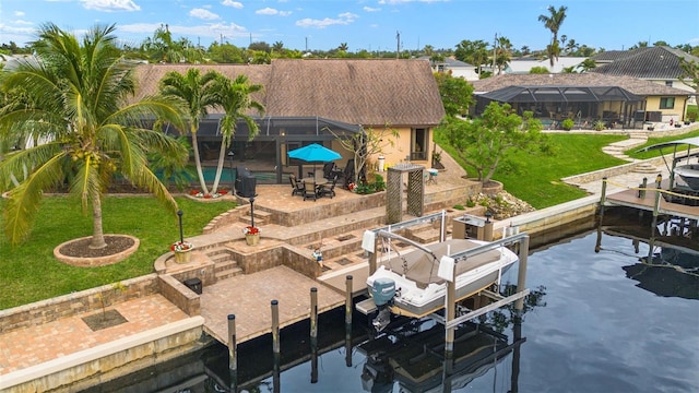 view of dock with a patio, a water view, glass enclosure, and a lawn