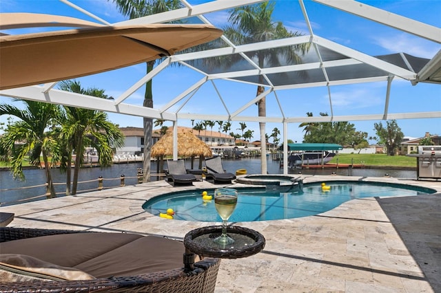 view of swimming pool with a water view, glass enclosure, an in ground hot tub, a grill, and a patio