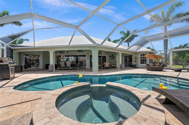 view of pool featuring a patio, area for grilling, an in ground hot tub, a lanai, and ceiling fan