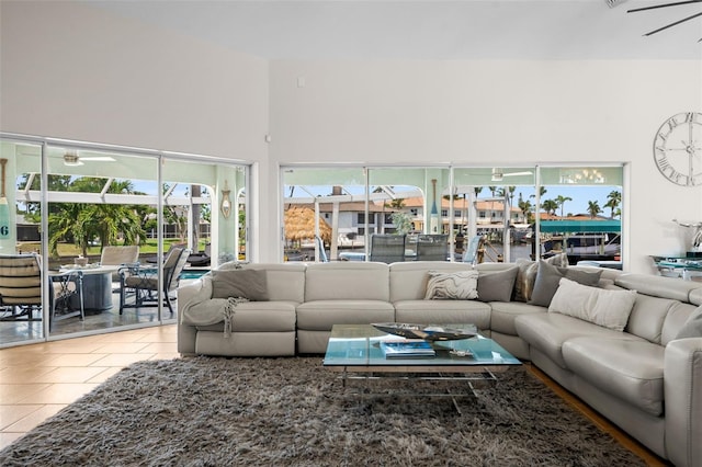 living room featuring light tile patterned flooring and ceiling fan