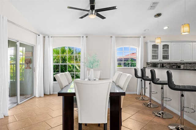 dining room with light tile patterned floors and ceiling fan