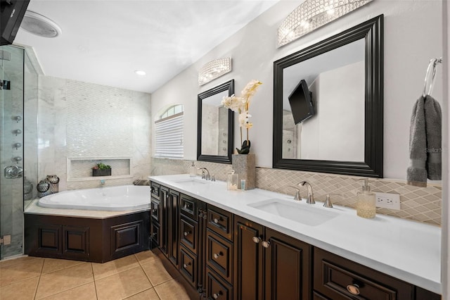 bathroom with tasteful backsplash, tile patterned floors, vanity, and plus walk in shower