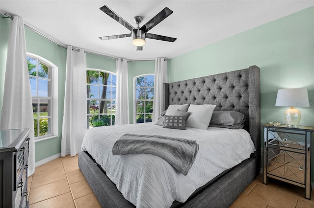 bedroom featuring light tile patterned floors and ceiling fan