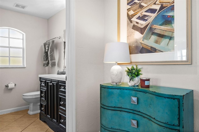 bathroom featuring tile patterned flooring, vanity, and toilet