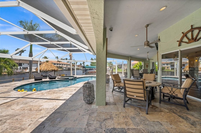 view of swimming pool featuring an in ground hot tub, a water view, a lanai, and a patio