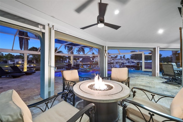 sunroom featuring ceiling fan