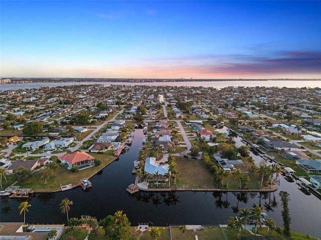 aerial view at dusk with a water view